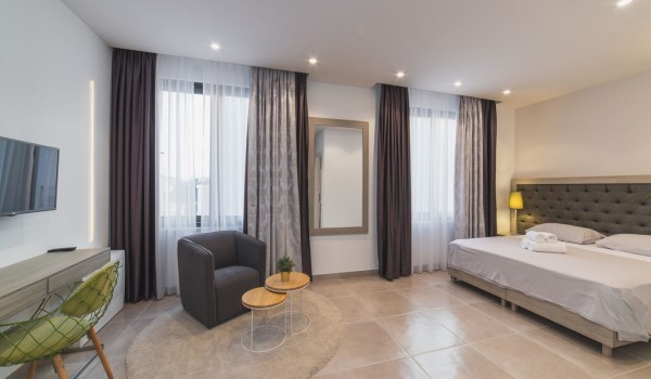 King size bed in a bedroom with en suite bathroom of a Croatia luxury vacation villa with private pool and parking