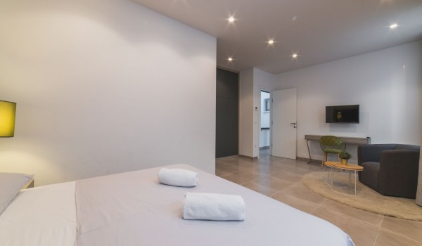 King size bed in a bedroom with en suite bathroom of a Croatia luxury vacation villa with private pool and parking