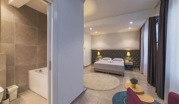 King size bed in a bedroom with en suite bathroom of a Croatia luxury vacation villa with private pool and parking