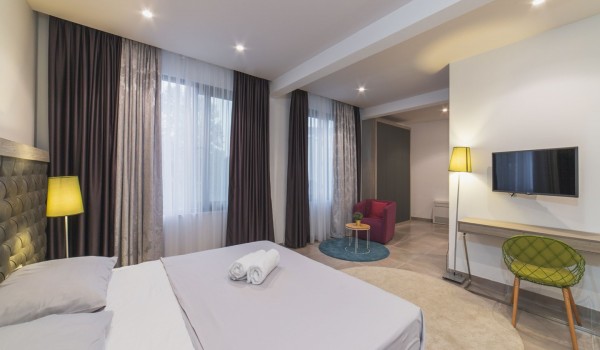 King size bed in a bedroom with en suite bathroom of a Croatia luxury vacation villa with private pool and parking