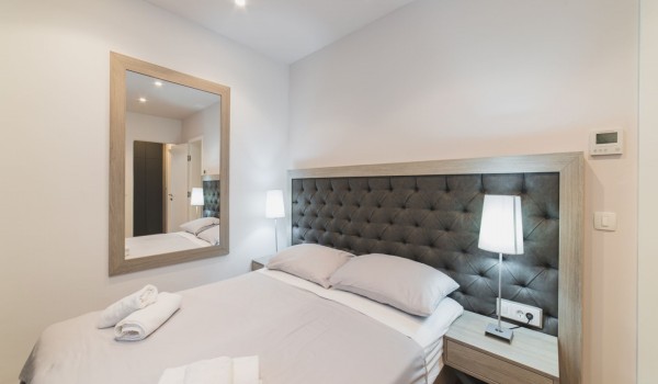 King size bed in a bedroom with en suite bathroom of a Croatia luxury vacation villa with private pool and parking