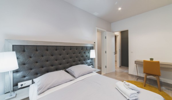 King size bed in a bedroom with en suite bathroom of a Croatia luxury vacation villa with private pool and parking