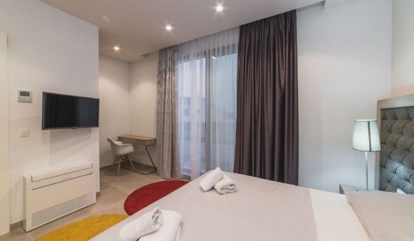 King size bed in a bedroom with en suite bathroom of a Croatia luxury vacation villa with private pool and parking