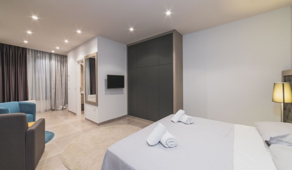 King size bed in a bedroom with en suite bathroom of a Croatia luxury vacation villa with private pool and parking