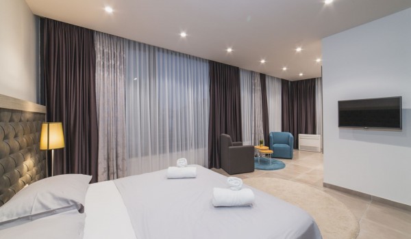 King size bed in a bedroom with en suite bathroom of a Croatia luxury vacation villa with private pool and parking