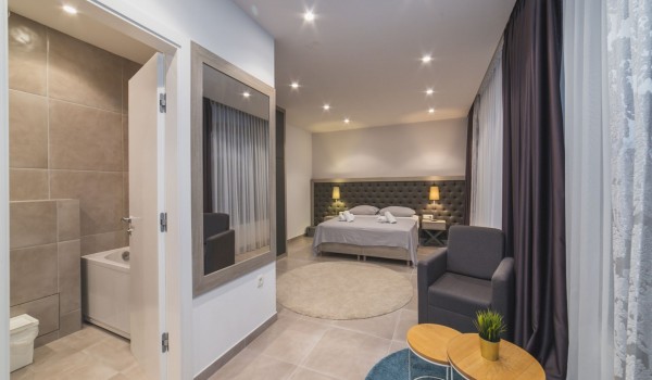 King size bed in a bedroom with en suite bathroom of a Croatia luxury vacation villa with private pool and parking