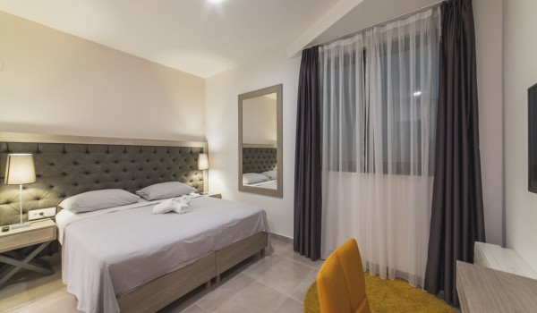 King size bed in a bedroom with en suite bathroom of a Croatia luxury vacation villa with private pool and parking