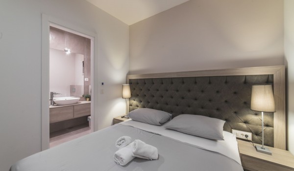 King size bed in a bedroom with en suite bathroom of a Croatia luxury vacation villa with private pool and parking