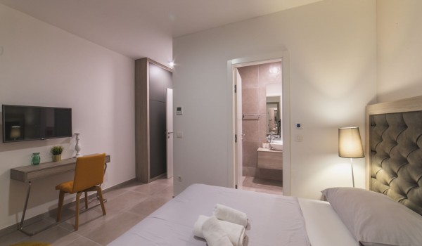 King size bed in a bedroom with en suite bathroom of a Croatia luxury vacation villa with private pool and parking