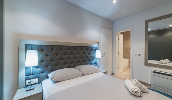 King size bed in a bedroom with en suite bathroom of a Croatia luxury vacation villa with private pool and parking