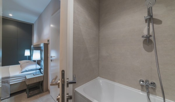 King size bed in a bedroom with en suite bathroom of a Croatia luxury vacation villa with private pool and parking