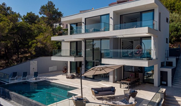 An exterior of the luxury holiday villa for 12 Korcula Miracul with a private pool, a sun deck with loungers and a longe area on Korcula