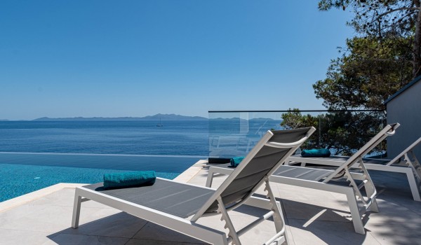 Sun loungers by the pool of the seafront luxury holiday villa Miracul Korcula with a private gym in Prizba
