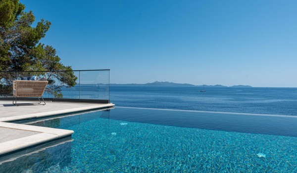 A view from the private infinity pool by the beach of the seafront luxury villa for 12 Miracul Korcula with a private gym in Prizba