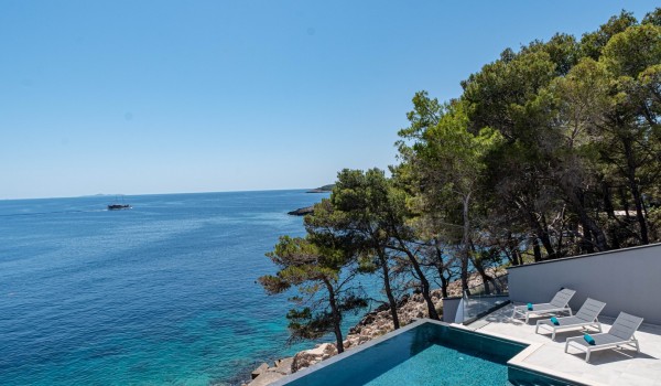 Sea view from the private infinity pool by the beach of the seafront luxury villa for 12 Miracul Korcula with a private gym in Prizba