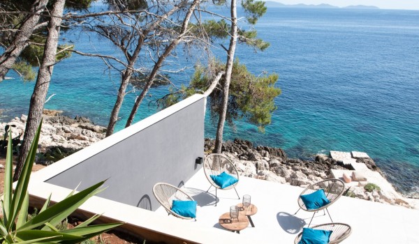Private seafront terrace with a lounge zone in front of the luxury 6-bedroom villa Miracul Korcula for vacations with friends and family on Korcula