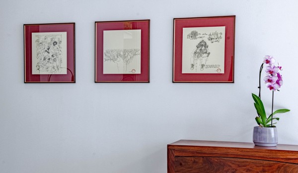 Interesting art triptych, and a flower on a wooden cabinet in the hall of the private holiday villa Miracul Korcula with a pool and gym