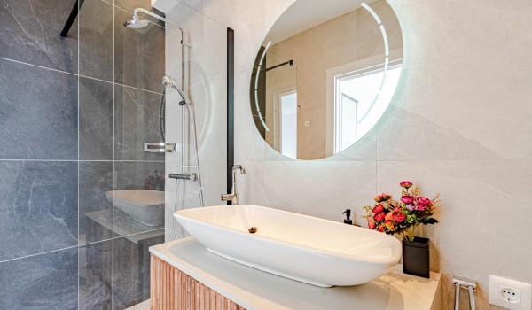 An elegant  bathroom with a shower, vanity unit and toilet of a Croatia luxury beachfront villa Miracul for 12 on Korcula