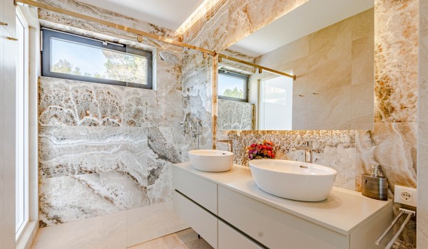 An elegant  bathroom with a shower, vanity unit and toilet of a Croatia luxury beachfront villa Miracul for family vacations on Korcula