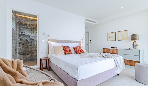 Interior of bedroom with en suite bathroom and king-size bed in a  luxury villa by the sea for rent on the island of Korcula