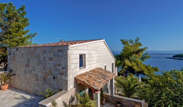 A view of the covered main entrance decorated with flowers of the Croatia  luxury villa Bliss on Brač