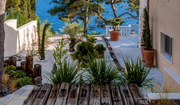 The richly decorated garden of the Croatia  luxury villa for rent Brač, in Sumartin near pebble beach