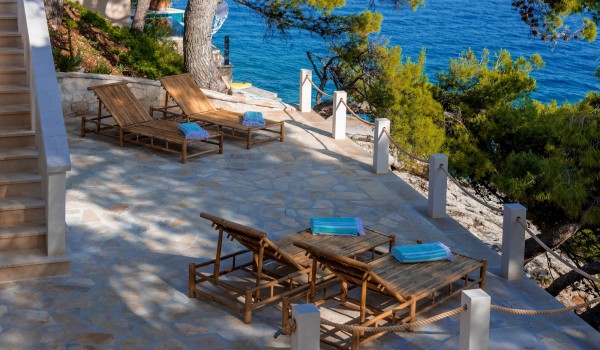 Wooden deckchairs with details on the stone-paved terrace of a Croatia luxury villa on Brač