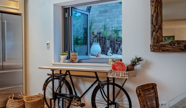 Modernly decorated part of the kitchen with a view of the garden of a luxury villa for rent and vacation Brač