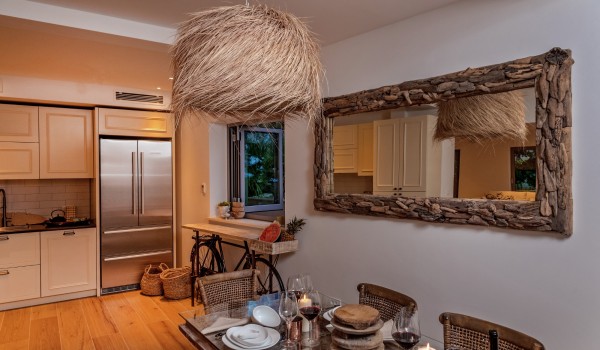 A view of the luxuriously decorated dining table with chairs next to the kitchen in the luxury villa Brač