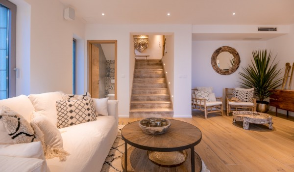 View of a modern living room with a guest bathroom and stairs in a vacation villa on Brač