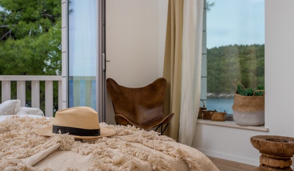 View of the dense pine forest from the spacious bedroom of the luxury villa Bliss on the island of Brač