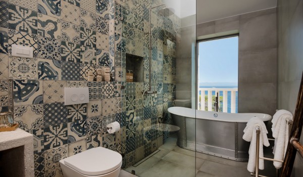 Modern en suite bathroom with sink, shower cabin, bathtub and various details of the luxury villa Bliss Brač
