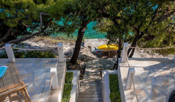 A stone-paved staircase leading from the luxury holiday villa Bliss to the sea on the island of Brač