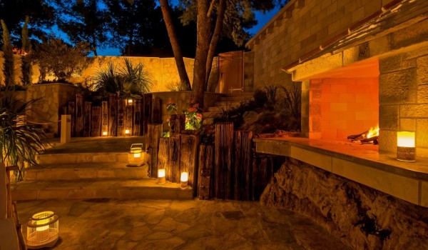 Stone-paved stairs in a romantic atmosphere that lead to the fireplace of this family vacation villa Brač by pebble beach