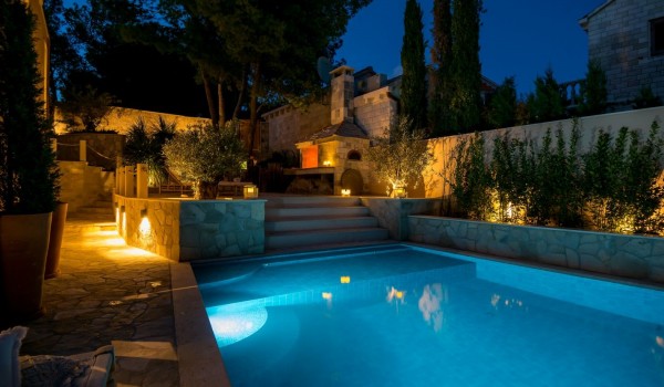 A romantic oasis next to the spacious pool and outdoor fireplace in the evenings on the property of this rental luxury villa Brač