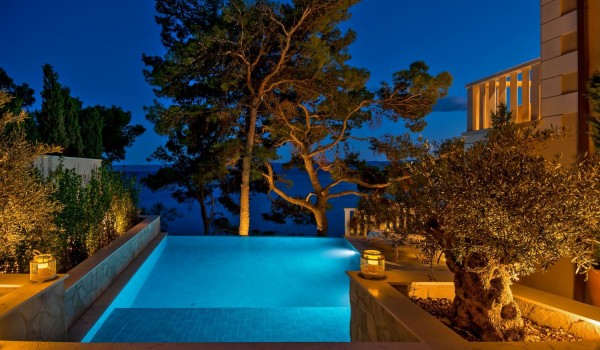 A romantic view from the top of the stairs leading to the spacious pool of the luxury villa Brač by the pebble beach
