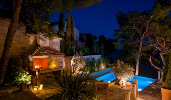 A romantic oasis next to the spacious pool and outdoor fireplace in the evenings on the property of this rental villa