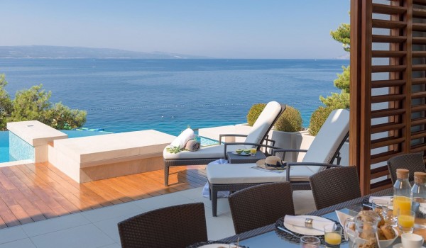 Exit from the dining room to the terrace with sunbeds and a large swimming pool next to the beach of the luxury villa for rent Brela Pride in Brela with chef service