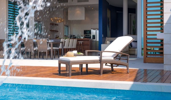 Interior living space with open space living room and kitchen next to a beautiful children friendly pebble beach of luxury villas for rent and family holidays