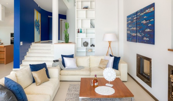 Comfortable sofas in the air-conditioned living room with a view of the staircase and the kitchen of the luxury villa for rent Brela Pride