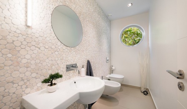 Elegant bathroom with sink, toilet and bidet in a private villa for vacation and rental with a swimming pool in Brela