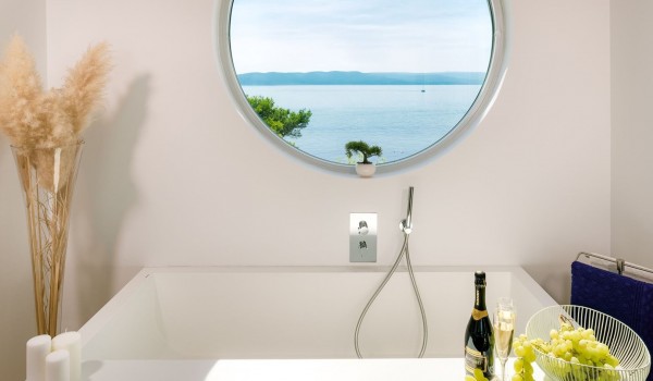 View of the sea from a private bathroom with a designer bathtub in a pet-friendly luxury villa for a vacation with family and friends in Brela