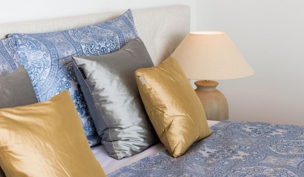 Decorative pillows on a comfortable king size bed in a modern bedroom of a private villa in Brela with a heated pool and private parking for 10 people