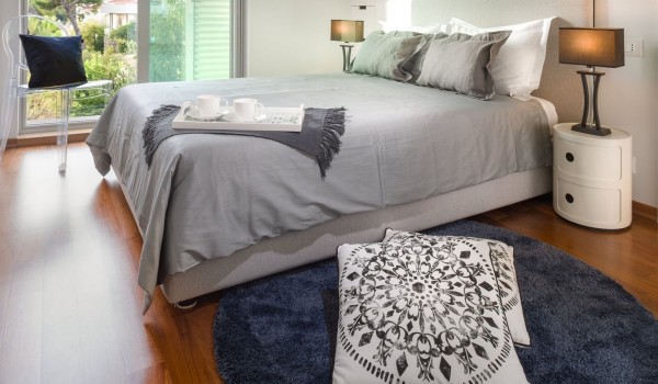 A spacious air-conditioned bedroom with a king-size bed, Smart TV, and Wi-Fi in a family luxury villa by the sea in Brela