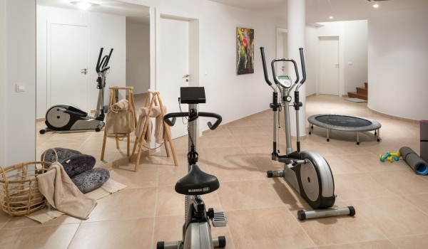 Private gym with exercise equipment in a luxury villa for rent and family vacation with friends Brela Pride by the beach with a view of the sea in Brela