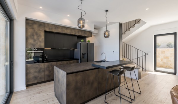 Fully equipped kitchen area of the luxury sea view villa with refrigerator and oven for family vacations