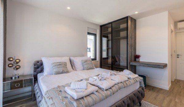 Bedroom of Croatia luxury rental villa with king-size bed and bathroom for family vacations