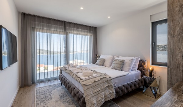 Modern design bedroom of Croatia luxury sea view villa with king-size bed and SMART TV for vacation