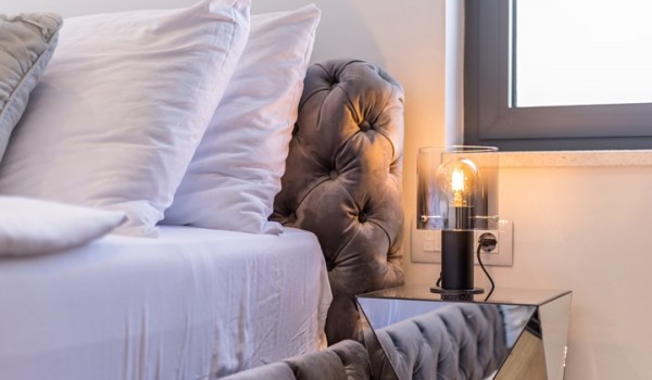 Bedroom of the luxury pool villa Seven Seas with night stand and lamp for family vacation