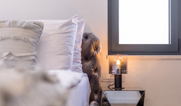 Bedroom of Croatia luxury holiday villa with king-size bed and night stand with lamp for rent